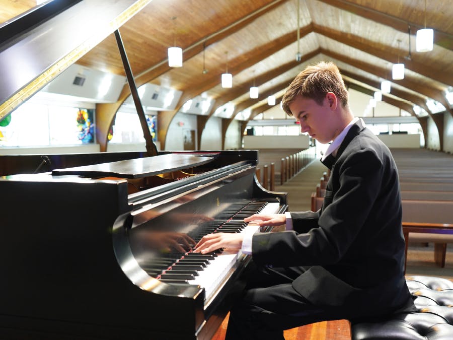 Josiah Oostdyk, a student in the Vero Beach Opera Piano Scholarship Program warms up before the 2024 Spring Concert.